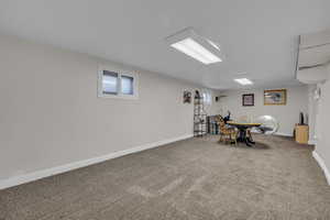 Recreation room in basement featuring carpet and baseboards
