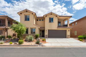 Mediterranean / spanish-style home featuring stucco siding, a tile roof, a garage, and concrete driveway