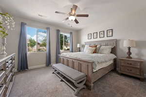 Carpeted bedroom featuring baseboards and a ceiling fan