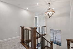 Stairs with a chandelier, recessed lighting, carpet floors, and baseboards