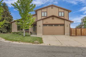 View of front of home featuring concrete driveway, brick siding, and an attached garage
