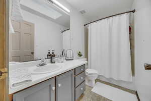 Full bathroom with vanity, toilet, and shower / bath combo