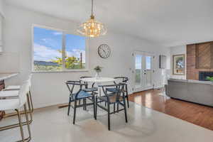 Dining room with a chandelier, a fireplace, and baseboards