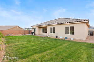 Rear view of house featuring stucco siding, central air condition unit, a patio area, and a tile roof