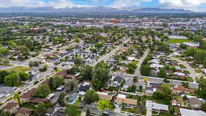 Aerial view of property's location featuring a mountain backdrop and nearby suburban area