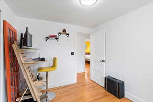 Second bedroom with baseboards and light wood-style floors