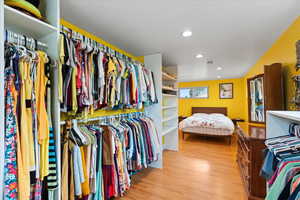 Walk in closet featuring wood finished floors