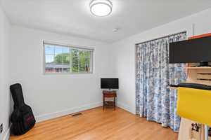 Second bedroom with wood finished floors and baseboards