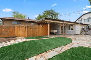 Backyard with flagstone patio and turf
