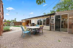 View of patio featuring fence and outdoor dining space