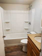 Full bath featuring toilet, wood finished floors, vanity