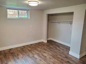 Basement master bedroom featuring baseboards, a closet