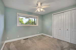 Unfurnished bedroom with carpet floors, baseboards, and a closet