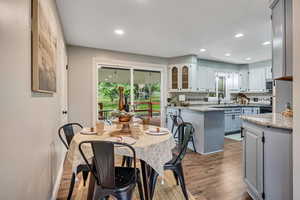 Dining area featuring wood finished floors and recessed lighting