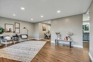 Sitting room featuring wood finished floors, recessed lighting, and baseboards