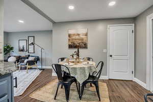 Dining room featuring baseboards, recessed lighting, and dark wood-style floors