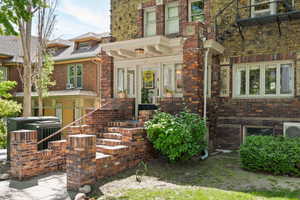 Doorway to property with brick siding