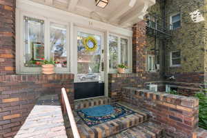 Entrance to property featuring covered porch