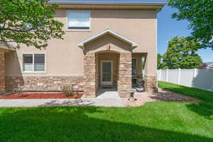 View of front of property featuring stone siding and stucco siding