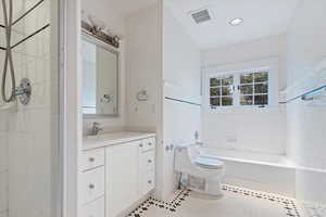 Full bathroom with a shower, toilet, tile patterned flooring, vanity, and a tub