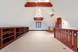 Bonus room featuring vaulted ceiling and carpet floors