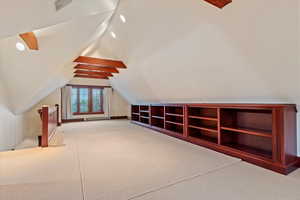 Additional living space featuring carpet flooring and lofted ceiling