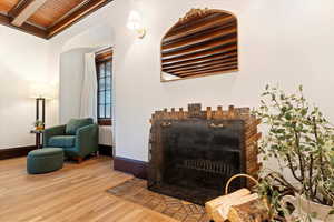 Detailed view of wood finished floors, baseboards, and arched walkways