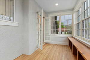Unfurnished sunroom with french doors