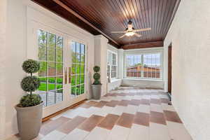 Unfurnished sunroom with french doors