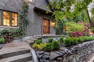 Entrance to property with stucco siding