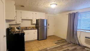 Kitchen featuring New Range and Refrigerator., New Wood grain Laminate Flooring.