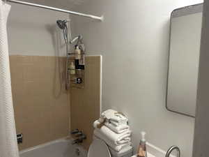 Full Bathroom with new toilet, tile patterned flooring, tub / shower combination, vanity, and a textured ceiling