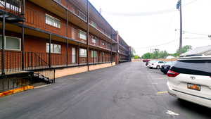View of building exterior with parking