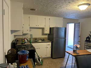 Kitchen/Dining featuring New Range and Refrigerator., New Wood grain Laminate Flooring.