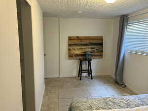 Bedroom featuring light pattern tile floor.