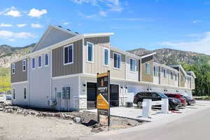 View of front of home with a mountain view, board and batten siding, and an attached garage
