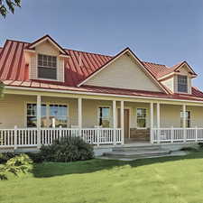 Beautiful farmhouse with metal roof and large porch to watch the sunrise