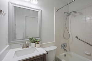 Full bathroom featuring vanity, shower / washtub combination, and toilet