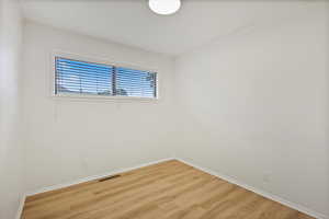 Unfurnished room featuring baseboards and wood finished floors