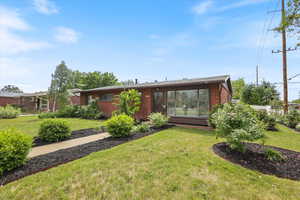 View of front facade featuring brick siding and a front lawn
