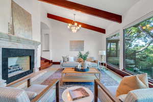 Marble fireplace, beams, and huge picture windows