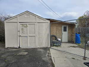View of shed featuring fence
