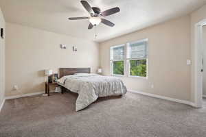 Carpeted bedroom with baseboards and ceiling fan