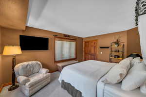 Bedroom with carpet flooring and baseboards