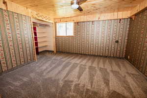 Spare room with carpet flooring and wooden ceiling