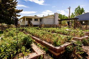 View of yard featuring a vegetable garden and fence
