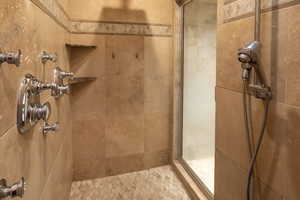 Full bath featuring a tile shower