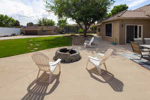 View of patio / terrace featuring an outdoor fire pit and a trampoline