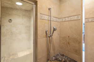 Full bathroom featuring a shower stall