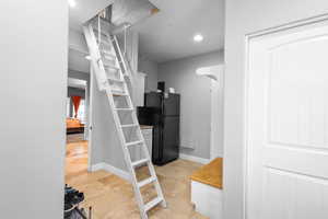 Hall featuring recessed lighting, baseboards, and light tile patterned floors